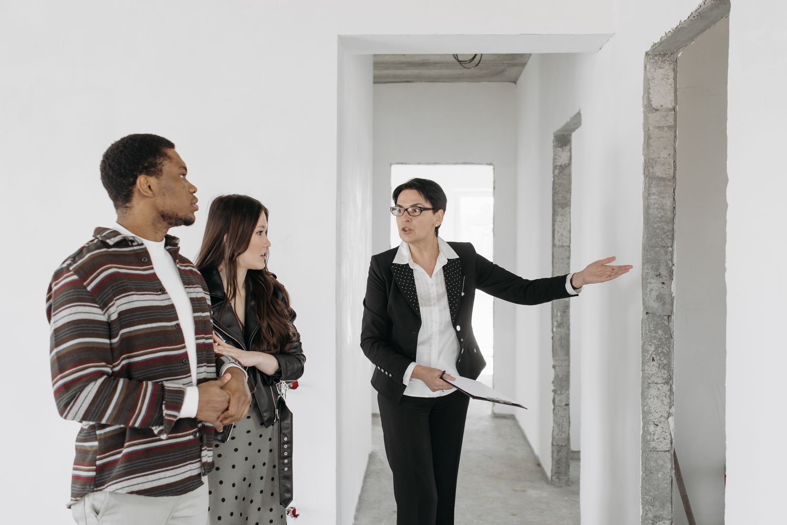 Agent handing keys to happy new homeowners